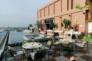 a restaurant on the roof of a building with tables and chairs at Centara Ayutthaya in Phra Nakhon Si Ayutthaya