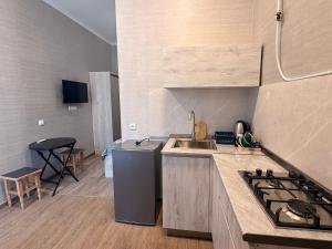 a kitchen with a sink and a stove at Oasis in Akhaltsikhe