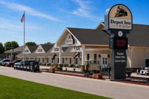 a building with a sign in front of a hotel at Depot Inn & Suites in La Plata