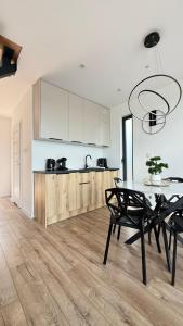 a kitchen with a table and chairs and a counter at Sosina Dreams in Jaworzno