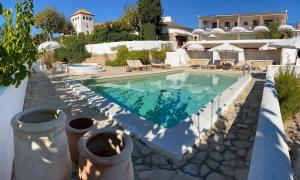 a swimming pool with blue water in a yard at Mas Boronat Resort in Salomó +37 photos