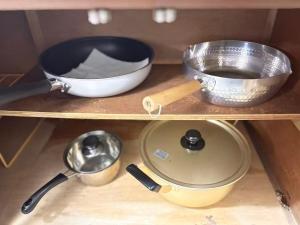 a wooden shelf with various kitchen utensils on it at Dons House in Fukuoka +12 photos