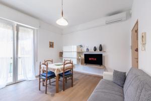 a living room with a couch and a table and chairs at Due passi dal mare - Residence Sirena in Punta Marina