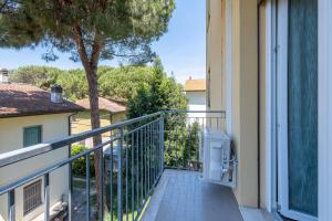 a balcony of a house with a tree at Due passi dal mare - Residence Sirena in Punta Marina