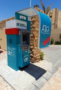 an atm machine sitting in front of a building at Azad Siwa Hotel in Siwa