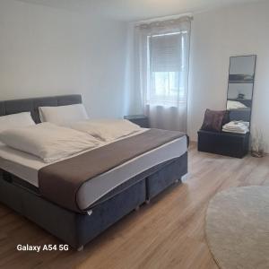 a bedroom with a large bed and a window at Gasthaus Sonne 2 in Braunsbach