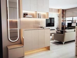 a living room with a couch and a chair at The Fermin Premium Studios in Ho Chi Minh City +31 photos