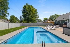 a swimming pool in the backyard of a home at Lambeau View Pool Rooftop Entertainment Room in Green Bay