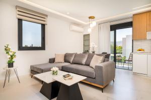 a living room with a couch and a table at Besa Luxury Villas in Kos