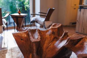 a wooden chair in the middle of a room at The Nook - Sauna, Pool, Ice Bath in Celje