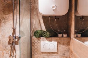 a bathroom with a shower and a sign with the olympics at The Nook - Sauna, Pool, Ice Bath in Celje +33 photos