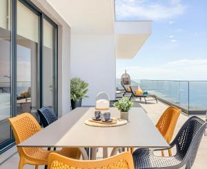 a dining room with a table and chairs at Villa Serenity by Rentallido in Prazeres
