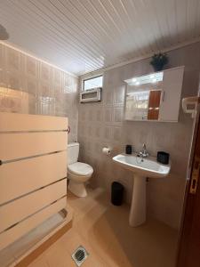 a bathroom with a toilet and a sink at The Village Studio AVLI Upper Vrasna in Nea Vrasna +9 photos