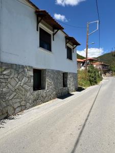a stone building on the side of a road at The Village Studio AVLI Upper Vrasna in Nea Vrasna