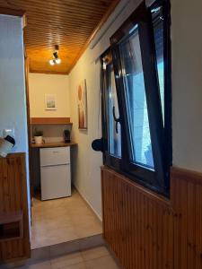 a hallway with a large window in a house at The Village Studio AVLI Upper Vrasna in Nea Vrasna