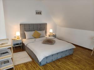 a bedroom with a large bed with two tables and two lamps at Baroc Boutique Hotel in Topliţa