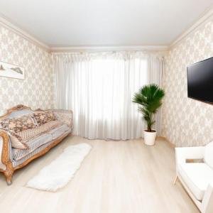 a bedroom with a bed and a potted plant at Кардиоцентр in Dnipro