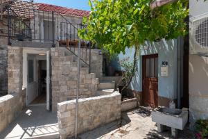 a house with a staircase leading up to a door at Balatura House in Trogir