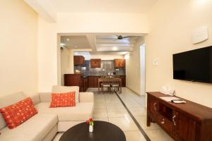 a living room with a couch and a flat screen tv at Dutch Manor Boutique Hotel in Cochin