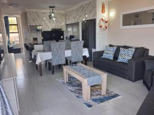 a living room with a couch and a table at Ocean Breeze 12 Boulder Bay in Ballito