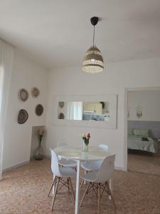 ein weißes Esszimmer mit einem weißen Tisch und Stühlen in der Unterkunft B&BCasamia in Modugno