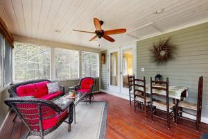 a living room with a couch and a ceiling fan at Gingerbread Cottage in Sugar Hill
