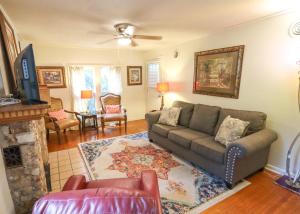 a living room with a couch and a fireplace at Over the Rainbow Suites in Eureka Springs