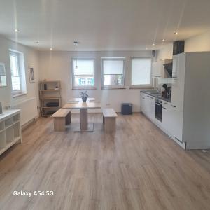 a kitchen with a table in the middle of a room at Gasthaus Sonne 1 in Braunsbach