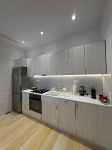 a kitchen with a sink and a stove top oven at Small home Pyrgos in Panormos