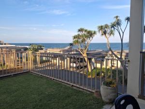 a balcony with a view of the ocean at Ocean Breeze 12 Boulder Bay in Ballito