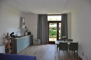 a kitchen and living room with a table and chairs at L'Oasi Amena - Loft in Ameno