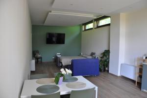 a living room with a bed and a table at L'Oasi Amena - Loft in Ameno