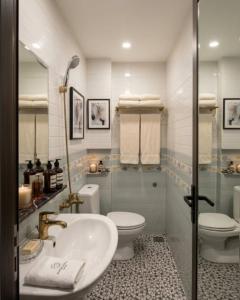 a bathroom with a sink and a toilet and a shower at An Phú Nguyễn Hoàng Hotel in Hanoi +8 photos