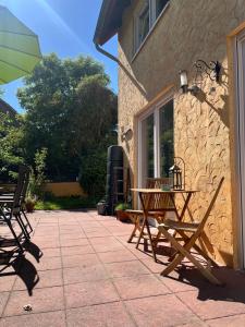 a patio with two wooden chairs and an umbrella at Family-friendly accommodation in Seesen