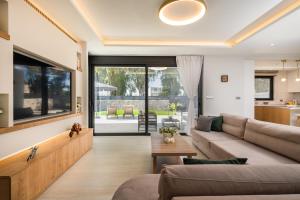 a living room with a couch and a table at Besa Luxury Villas in Kos