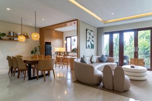 a living room and dining room with a couch and a table at Breeze Blows City View Villa 4 Bedrooms and 1 Familly Bedroom With a Private Heated Swimming Pool and a Billiard Table in Bandung