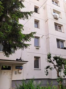a large white building with a sign on it at Ariana Urban Loft in Târgu-Mureş