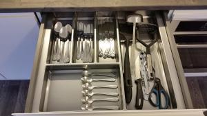 a drawer with silver utensils in it at Tehvandi Ski Apartment in Otepää