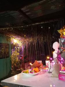 a table with a bowl of food and a waterfall at Cozy House Hostel in Ella