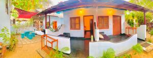 a small white house with a red roof at saha surf camp in Arugam Bay