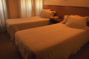 ポンタ・デルガダにあるResidencial D. João IIIのベッド2台、電話が備わるホテルルームです。