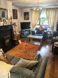 a living room with a couch and a table at Maryem Ana in Kenmare