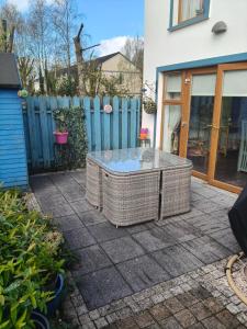 a patio with a table and a fence at Maryem Ana in Kenmare