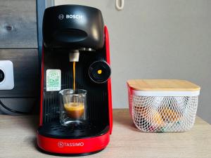 a black and red coffee maker on a table at Zen Appartement Centre-ville historique in Niort +18 photos
