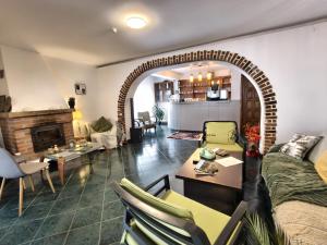 a living room with a couch and a table and a fireplace at Baroc Boutique Hotel in Topliţa