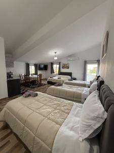 a large room with three beds in it at Daydream Villas in Shkodër