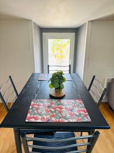 a black dining room table with a plant on it at Zen Appartement Centre-ville historique in Niort
