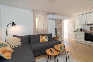 a living room with a gray couch and a table at Balatura House in Trogir