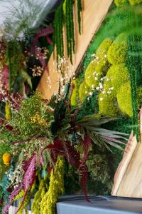 a bunch of plants are on a wall at Malpensa Elegant Loft in Gallarate +2 photos