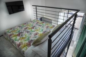 a bedroom with a bed with a quilt on it at Malpensa Elegant Loft in Gallarate